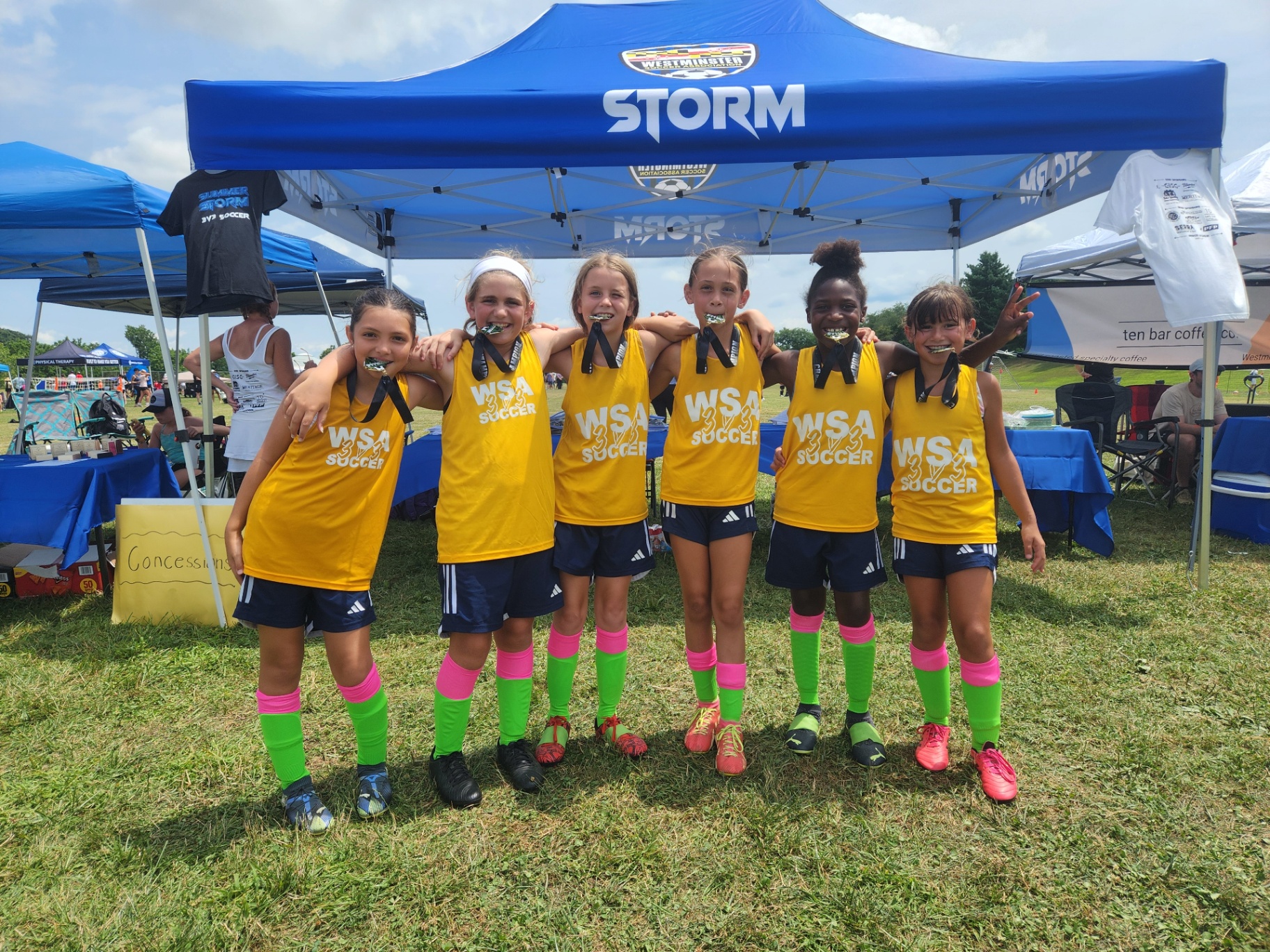 2025 — WSA girls team biting their championship medals
